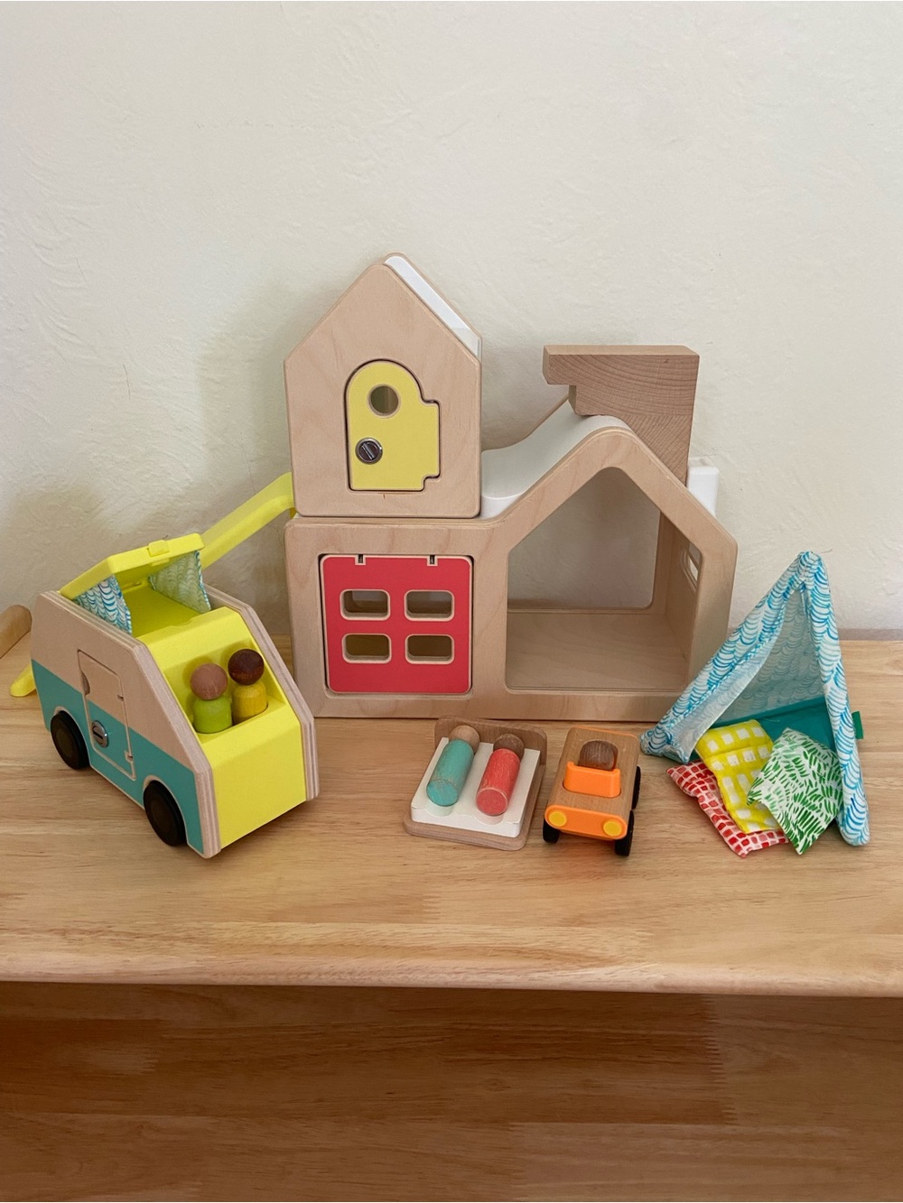 Lovevery modular wooden playhouse with car, camper, tent, and peg dolls